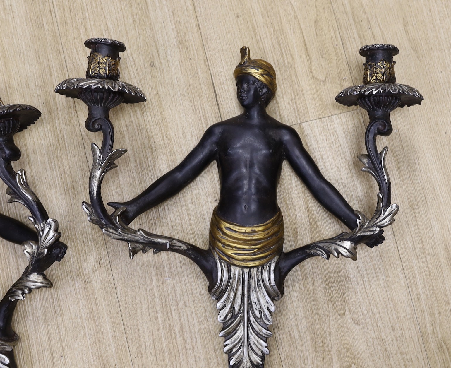 A pair of Blackamoor two branch wall lights, 53cm tall